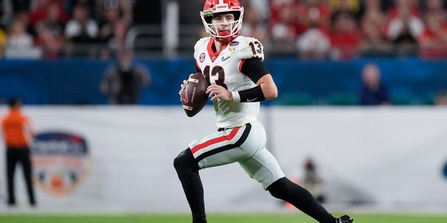 Georgia quarterback Stetson Bennett looks to pass out of the pocket against Michigan during the second half of the Orange Bowl NCAA College Football Playoff semifinal game, Friday, Dec. 31, 2021, in Miami Gardens, Florida.