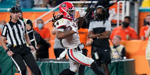 Georgia running back James Cook scores against Michigan during the second half of the Orange Bowl NCAA College Football Playoff semifinal game, Friday, Dec. 31, 2021, in Miami Gardens, Fla. (Associated Press)