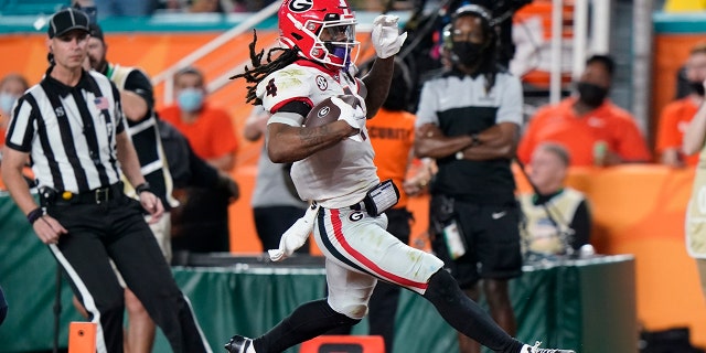 Georgia running back James Cook scores against Michigan during the second half of the Orange Bowl NCAA College Football Playoff semifinal game, Friday, Dec. 31, 2021, in Miami Gardens, Fla. (Associated Press)