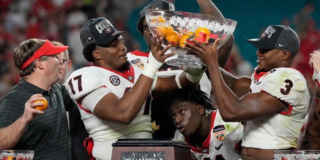 Georgia head coach Kirby Smart and players celebrate their win against Michigan in the Orange Bowl NCAA College Football Playoff semifinal game, Friday, Dec. 31, 2021, in Miami Gardens, Fla. Georgia won 34-11. (Associated Press)