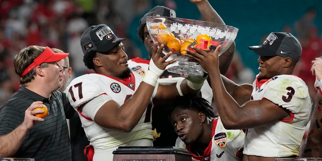 Georgia's head coach Kirby Smart and the players celebrate their victory over Michigan in the Orange Bowl NCAA College Football Playoff semifinal match, Friday, December 31, 2021, in Miami Gardens, Florida, Georgia won 34-11. (Associated Press)