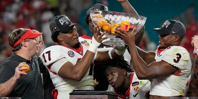 Georgia head coach Kirby Smart and players celebrate their win against Michigan in the Orange Bowl NCAA College Football Playoff semifinal game, Friday, Dec. 31, 2021, in Miami Gardens, Fla. Georgia won 34-11. (Associated Press)