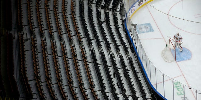 Ottawa Senators goaltender Matt Murray turns to face a bank of empty seats at the Scotiabank Arena during the first period of an NHL hockey game against the Toronto Maple Leafs, in Toronto, Saturday, Jan. 1, 2022. The Ontario Government reduced capacity at sporting events to a maximum of 1000 in a bid to stem the spread of the COVID-19 Omicron variant.