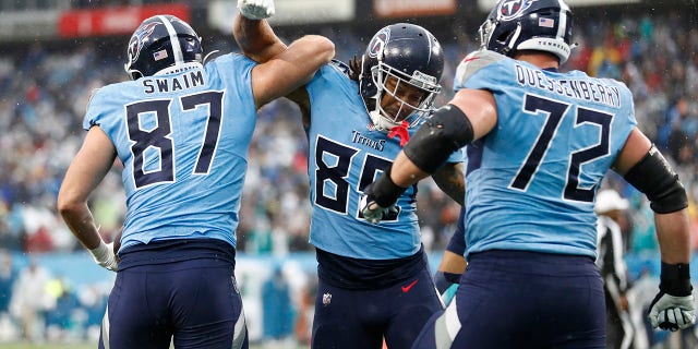 Tennessee Titans tight end Geoff Swaim (87) celebrates with MyCole Pruitt (85) after Swaim caught a touchdown pass against the Miami Dolphins in the first half of an NFL football game Sunday, Jan. 2, 2022, a Nashville, Tenn.