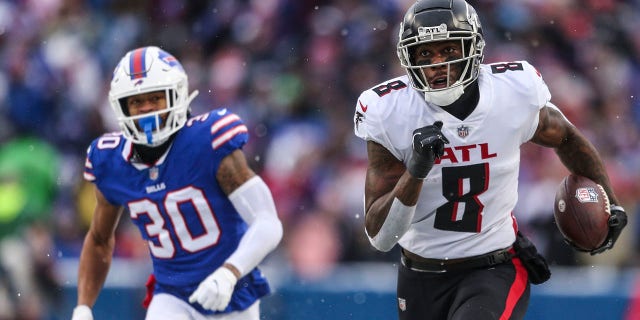 Atlanta Falcon Kyle Pitts (8) runs away from Buffalo Bill Dane Jackson (30) during the first half of a game Sunday, Jan. 2, 2022, a Orchard Park, N.Y.