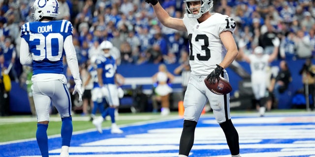 Las Vegas Raiders receiver Hunter Renfrow (13) celebrates in front of Indianapolis Colts safety George Odum (30) after catching an 11-yard touchdown pass during the second half of a game Jan. 2, 2022, in Indianapolis.