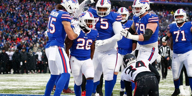 Atlanta Falcons cornerback Darren Hall (34) looks on as Buffalo Bills' Devin Singletary (26) celebrates with teammates after scoring a touchdown during the second half of an NFL football game Sunday, Jan. 2, 2022, in Orchard Park, N.Y.
