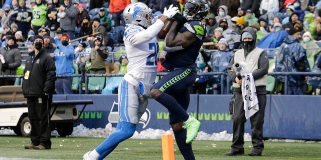 Seattle Seahawks wide receiver DK Metcalf, right, makes a catch for a touchdown in front of Detroit Lions cornerback Ifeatu Melifonwu, left, during the second half of an NFL football game, Sunday, Jan. 2, 2022, in Seattle.