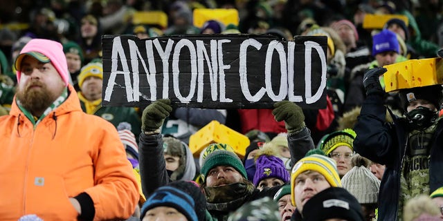 Fans watch during the first half of an NFL football game between the Green Bay Packers and the Minnesota Vikings at Lambeau Field Sunday, Jan. 2, 2022, in Green Bay, Wis.