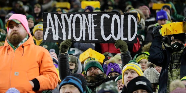 Fans watch during the first half of an NFL football game between the Green Bay Packers and the Minnesota Vikings at Lambeau Field Sunday, Jan. 2, 2022, in Green Bay, Wis.