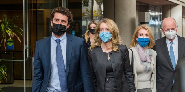 Elizabeth Holmes, center, leaves federal court in San Jose, Calif., Monday, Jan. 3, 2022. (AP Photo/Nic Coury)