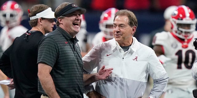 FILE - Georgia head coach Kirby Smart speaks with Alabama head coach Nick Saban before the first half of the Southeastern Conference championship NCAA college football game, Saturday, Dec. 4, 2021, in Atlanta. Georgia plays Alabama in the College Football Playoff national championship game on Jan. 10, 2022.