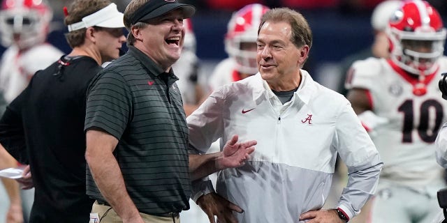 FILE - Georgia head coach Kirby Smart speaks with Alabama head coach Nick Saban before the first half of the Southeastern Conference championship NCAA college football game, Saturday, Dec. 4, 2021, in Atlanta. Georgia plays Alabama in the College Football Playoff national championship game on Jan. 10, 2022.
