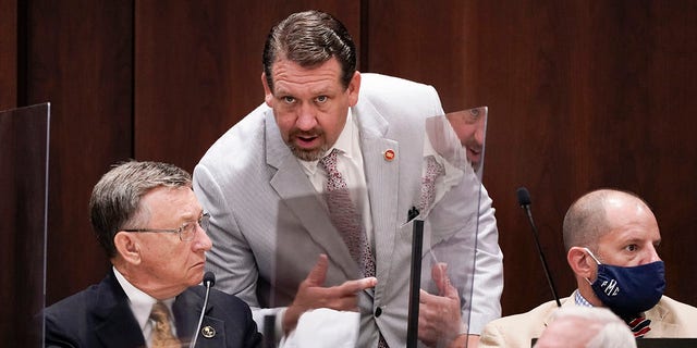 FILE - Rep. Jeremy Faison, R-Cosby, center, talks with Rep. Dan Howell, R-Georgetown, left, during a meeting, Aug. 11, 2020, in Nashville, Tenn. A top Tennessee House Republican lawmaker has apologized for losing his temper and being ejected from watching a high school basketball game after getting into a confrontation with a referee, including a brief gesture at pulling down the official's pants that is visible in video footage of the game. On Tuesday, Jan. 4, 2022 Rep. Jeremy Faison, 45, posted on Twitter that he "acted the fool tonight and lost my temper on a ref."