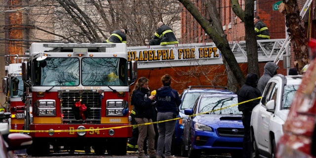 Philadelphia firefighters work at the scene of a deadly row house fire, Wednesday, Jan. 5, 2022, in the Fairmount neighborhood of Philadelphia. (AP Photo/Matt Rourke)