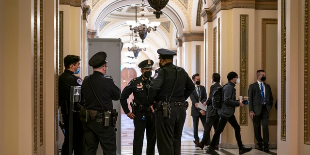 U.S. Capitol Police officers stand outside the House chamber in Washington, Thursday, Jan. 6, 2022.