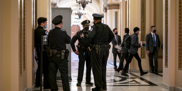 U.S. Capitol Police officers stand outside the House chamber in Washington, Thursday, Jan. 6, 2022.