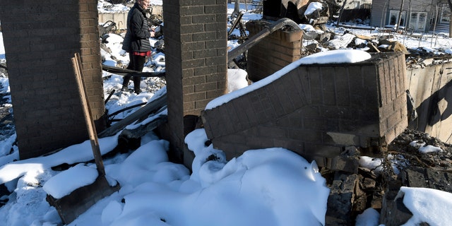 Barba Hickman surveys the rubble of her burned home in Louisville, Colo., on Jan. 2, 2022. (AP Photo/Thomas Peipert, File)