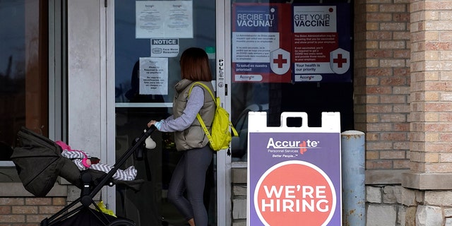 A hiring sign is seen outside of Accurate Personnel office (employment agency) in Buffalo Grove, Ill., Friday, Dec. 3, 2021.  