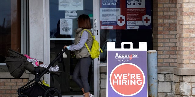 A hiring sign is seen outside a Accurate Personnel employment agency office in Buffalo Grove, Illinois, Dec. 3, 2021.  One of the fastest years of job creation in U.S. history stumbled at the finish line in December. 