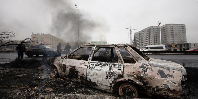 A car, which was burned after clashes, is seen on a street in Almaty, Kazakhstan, Friday, Jan. 7, 2022. 