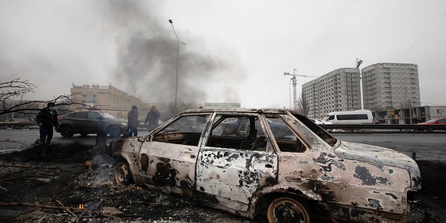 A car, which was burned after clashes, is seen on a street in Almaty, Kazakhstan, Friday, Jan. 7, 2022.