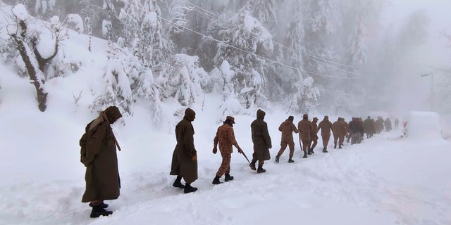 Army members take part in a rescue operation in a heavy snowfall-hit area in Murree, some 28 miles (45 kilometers) north of the capital of Islamabad, Pakistan, Saturday, Jan. 8, 2022. (Inter Services Public Relations via AP)