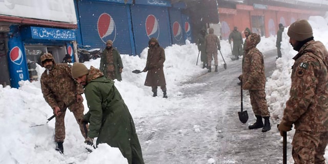 Army members take part in a rescue operation in a heavy snowfall-hit area in Murree, some 28 miles (45 kilometers) north of the capital of Islamabad, Pakistan, Saturday, Jan. 8, 2022. (Inter Services Public Relations via AP)