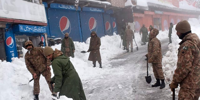 Members of the military take part in a rescue operation in an area affected by heavy snowfall in Murree, about 45 kilometers north of the capital of Islamabad, Pakistan, on Saturday, January 8, 2022 (Inter Services Public Relations via AP)