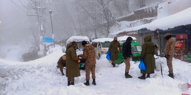 Army members take part in a rescue operation in a heavy snowfall-hit area in Murree, some 28 miles (45 kilometers) north of the capital of Islamabad, Pakistan, Saturday, Jan. 8, 2022.(Inter Services Public Relations via AP)