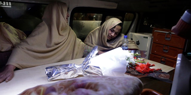 Women cry inside an ambulance after they lost their family members during a heavy snowfall-hit area in Murree, some 28 miles (45 kilometers) north of the capital of Islamabad, Pakistan, Saturday, Jan. 8, 2022. (AP Photo/Rahmat Gul)