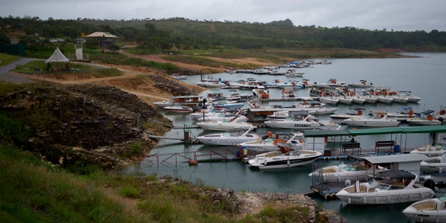 Tourist boats remain moored at a pier in the Furnas Reservoir after a huge slab of rock detached itself from a cliff and tipped over on boaters on Saturday, killing at least 10 people near the town of Capitolio, au Brazil, Sunday January 9, 2022 (AP Photo / Igor do Vale)