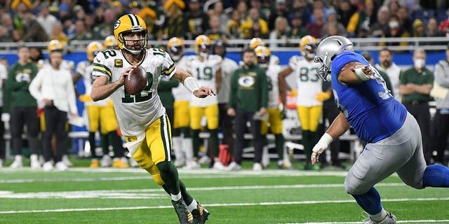 Green Bay Packers oyun kurucusu Aaron Rodgers, 12 numara, 9 Ocak 2022 Pazar günü Detroit'te Detroit Lions'a karşı bir NFL futbol maçının ilk yarısında mücadele ediyor.