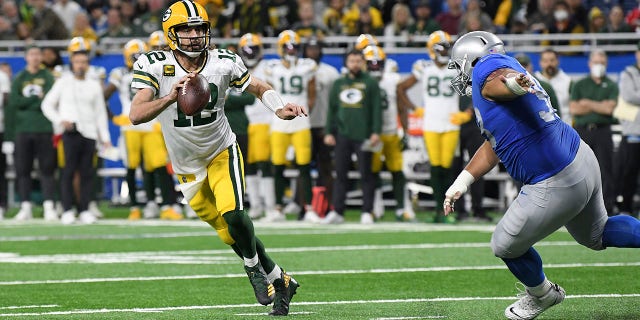 Green Bay Packers quarterback Aaron Rodgers, #12, fights during the first half of an NFL football game against the Detroit Lions, Sunday, Jan. 9, 2022, in Detroit.