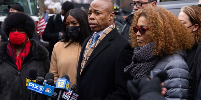 New York City Mayor Eric Adams, middle, speaks during a news conference outside an apartment building where a deadly fire occurred in the Bronx on Sunday, Jan. 9, 2022, in New York. (AP Photo/Yuki Iwamura)