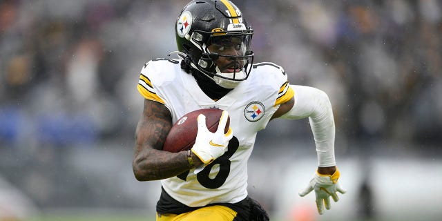 Pittsburgh Steelers wide receiver Diontae Johnson runs with the ball after making a catch against the Baltimore Ravens during the second half of an NFL football game, Sunday, Jan. 9, 2022, in Baltimore.