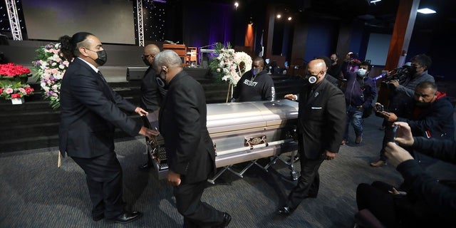 The casket of 14-year-old Valentina Orellana Peralta, killed on Dec. 23, 2021 by an LAPD police officer's stray bullet while shopping with her mother, is readied for her funeral at the City of Refuge Church in Gardena, Calif., on Monday. (AP Photo/David Swanson)
