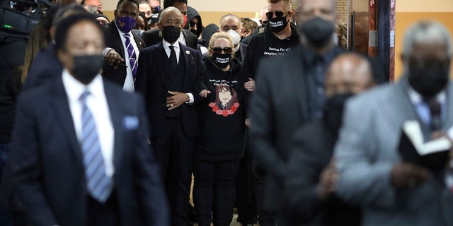 The Reverend Al Sharpton walks mother Soledad Peralto and father Juan Pablo Orellana into the funeral for 14-year-old Valentina Orellana Peralta, killed on Dec. 23, by a LAPD police officer's stray bullet while shopping with her mother, is readied for her funeral at the City of Refuge Church in Gardena, Calif., Monday, Jan. 10, 2022. (AP Photo/David Swanson)
