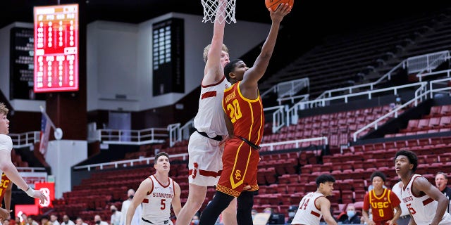 Stanford forward James Keefe ( 22 ) defends as Southern California guard Ethan Anderson ( 20 ) aims for the basket during the first half of an NCAA college basketball game Tuesday, Jan. 11, 2022, in Stanford, Calif.