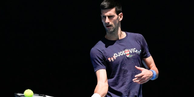 Defending men's champion Serbia's Novak Djokovic practices on Rod Laver Arena ahead of the Australian Open tennis championship in Melbourne, Australia, Wednesday, Jan. 12, 2022. AP Photo/Mark Baker)