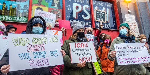 Teachers from the Earth School speak out on issues related to lack of COVID testing outside P.S. 64, Dec. 21, 2021, in New York. (AP Photo/Brittainy Newman, File)