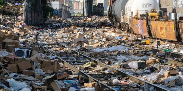 Shredded boxes and packages are seen at a section of the Union Pacific train tracks in downtown Los Angeles Friday, Jan. 14, 2022. (AP Photo/Ringo H.W. Chiu)