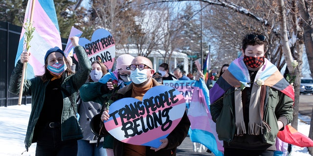 Advocates for transgender people march from the South Dakota governor's mansion to the Capitol in Pierre, S.D., on March 11, 2021. 