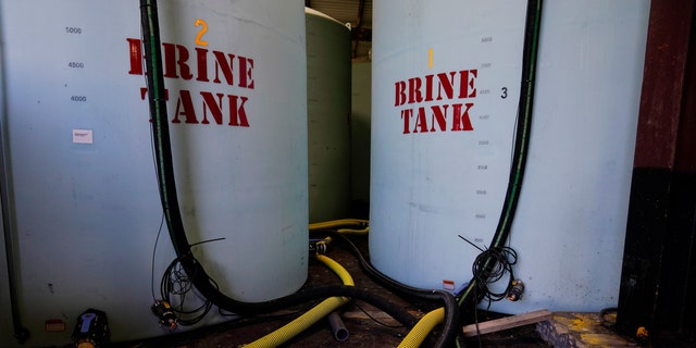 Hoes used to fill brine are seen near brine tank storage bins ahead of a winter storm at the GDOT's Maintenance Activities Unit location on Friday, Jan. 14, 2022, in Forest Park, Ga. (AP Photo/Brynn Anderson)