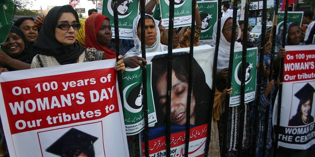 People rally demanding the release of Aafia Siddiqui, who was convicted in February 2010 of two counts of attempted murder, and who is currently being detained in the U.S. during International Women's Day in Karachi, Pakistan, Tuesday, March 8, 2011.