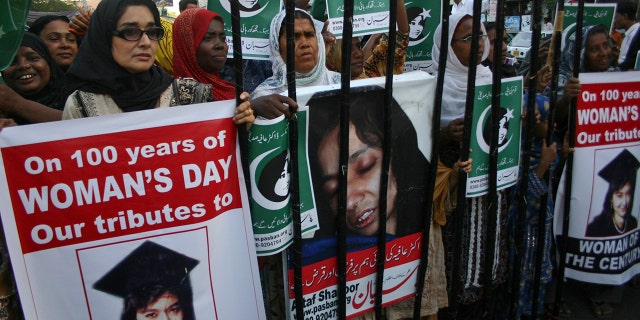 People rally demanding the release of Aafia Siddiqui, who was convicted in February 2010 of two counts of attempted murder, and who is currently being detained in the U.S. during International Women's Day in Karachi, Pakistan, Tuesday, March 8, 2011.