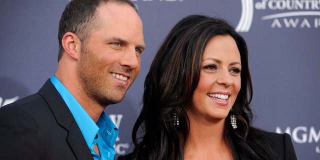Former Alabama quarterback Jay Barker, 왼쪽, and his wife country music singer Sara Evans arrive at the 46th annual Academy of Country Music Awards in Las Vegas on April 3, 2011. Barker was arrested Saturday, 1 월. 15, 2022, on a felony domestic violence charge, Tennessee authorities said. (AP 사진/크리스 피젤로, 파일)