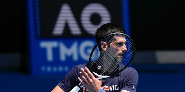 Defending men's champion Serbia's Novak Djokovic practices on Rod Laver Arena ahead of the Australian Open tennis championship in Melbourne, Australia, Jan. 12, 2022. 