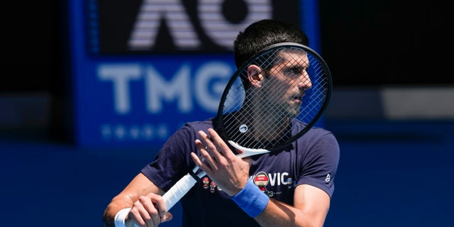 Defending men's champion Serbia's Novak Djokovic practices on Rod Laver Arena ahead of the Australian Open tennis championship in Melbourne, Australia, Jan. 12, 2022.