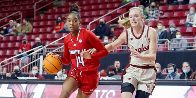Louisville guard Kianna Smith (14) drives the ball up the court as Boston College guard Cameron Swartz (1) defends during the first half of an NCAA college basketball game, Sunday, Jan. 16, 2022, in Boston.